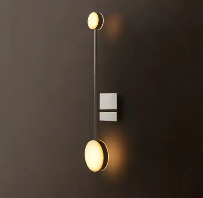 Modern wall sconce with alabaster shades and sleek design for elegant lighting.