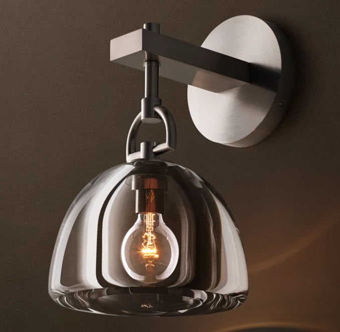 Gorvey Lighting brass sconce with glass shade and exposed bulb for modern decor.