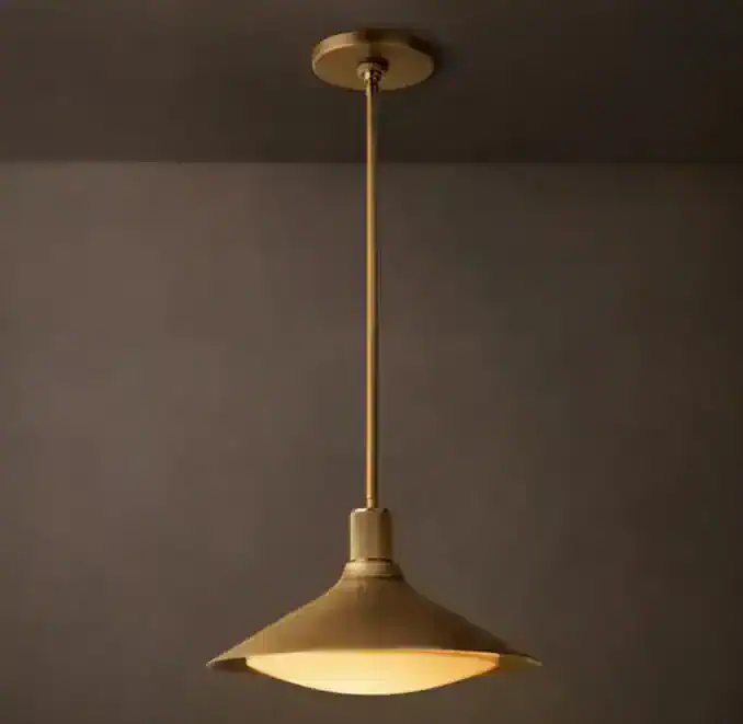 Brass pendant light fixture hanging from ceiling with a wide shade.