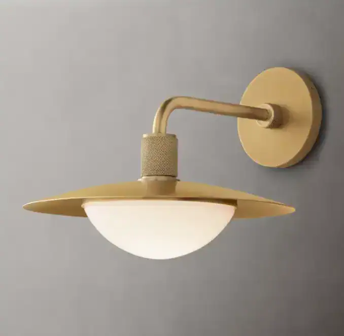 Gorvey Brass Glass Sconce with modern design and warm lighting.