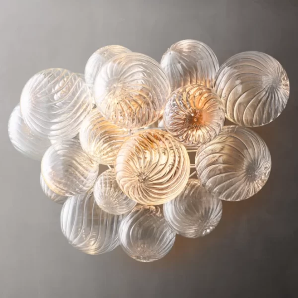 Elegant glass sconce with swirling patterns in Burnished Silver Leaf finish.
