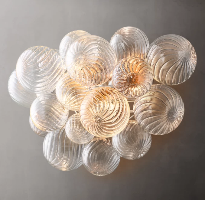 Elegant glass sconce with swirling patterns in Burnished Silver Leaf finish.