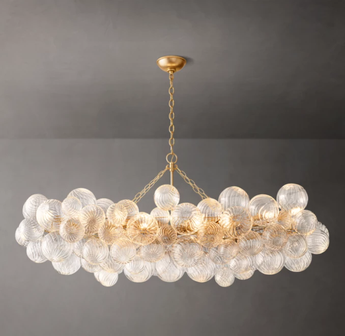 Elegant modern glass chandelier with multiple glass orbs and gold accents.