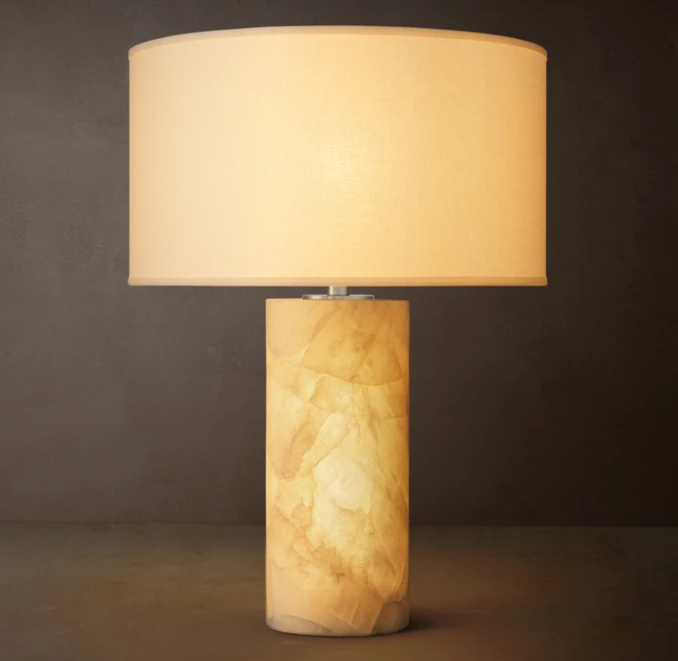 Gorvey Calcite Table Lamp with beige shade and cylindrical base.