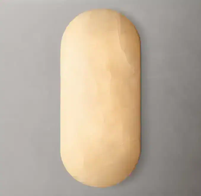 Modern wall sconce with rounded design for elegant lighting.