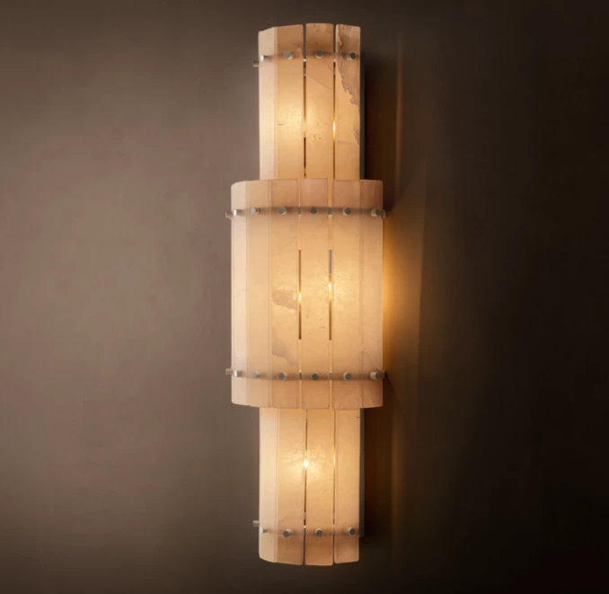 Grand round wall light from Gorvey with alabaster finish and warm illumination.