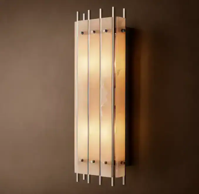 Modern wall sconce with polished nickel finish and vertical metal accents.