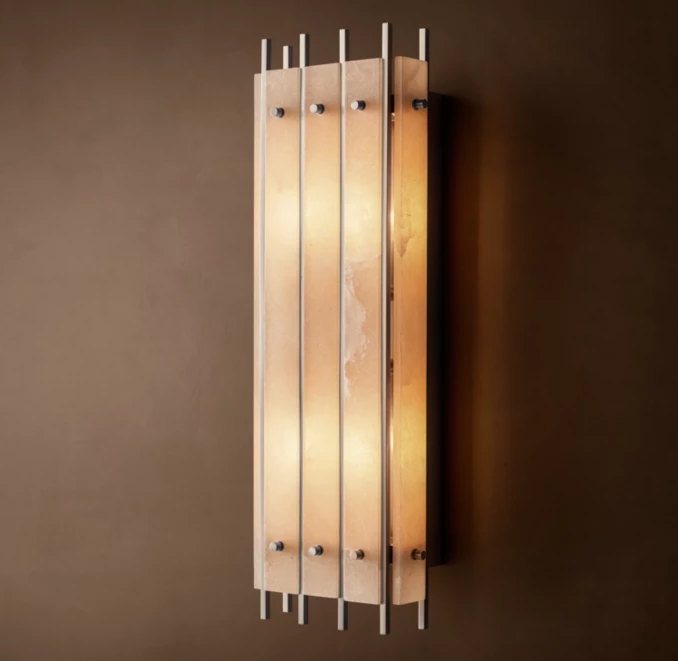 Elegant alabaster wall sconce with vertical metal accents for modern decor.