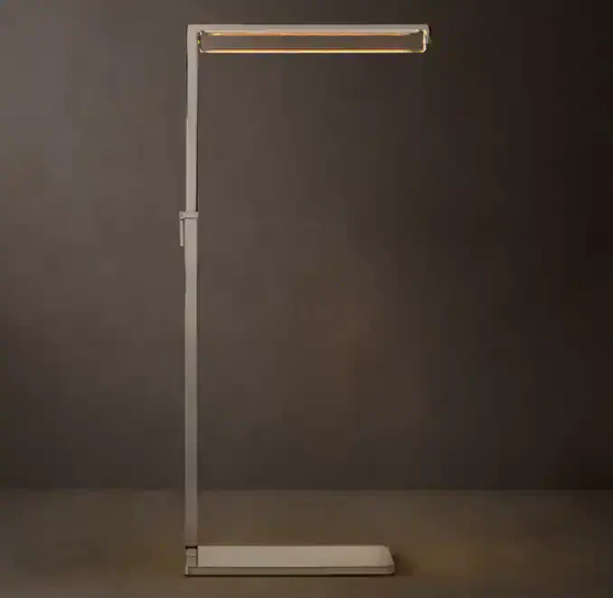 Modern crystal task lamp with brass frame for stylish lighting.