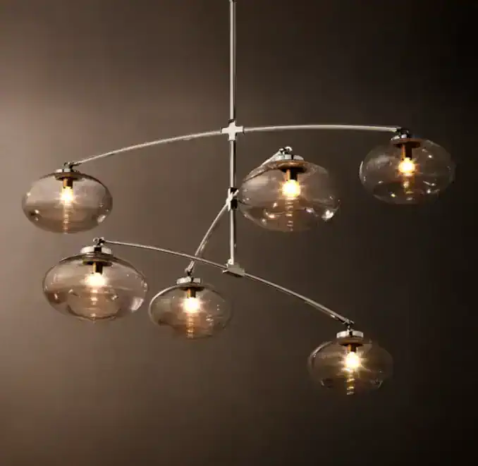 Contemporary glass chandelier with multiple round glass shades and warm lighting.