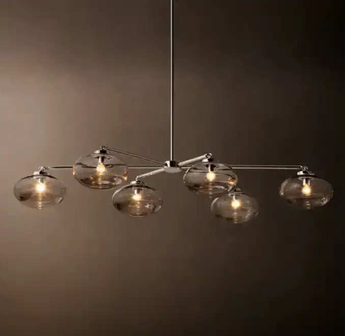 Modern glass chandelier with multiple glass globes and sleek metal arms.