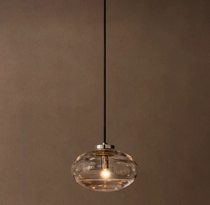 Gorvey glass pendant light hanging from ceiling with steel fixture.