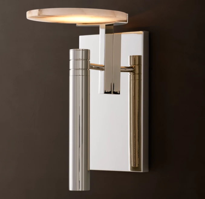 Modern wall light with disc-shaped LED and metallic finish for stylish interiors.