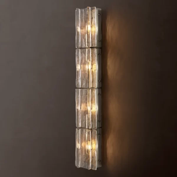 Modern glass sconce with lattice design and warm lighting.