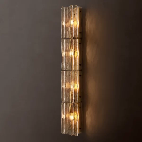 Modern glass sconce with warm lighting in smoke cast glass finish.