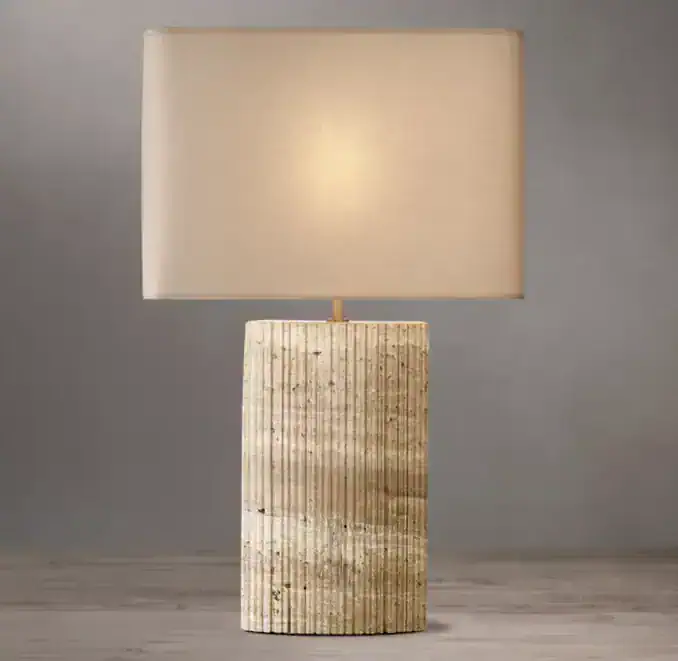 Gorvey lighting lamp with travertine base and rectangular linen shade.