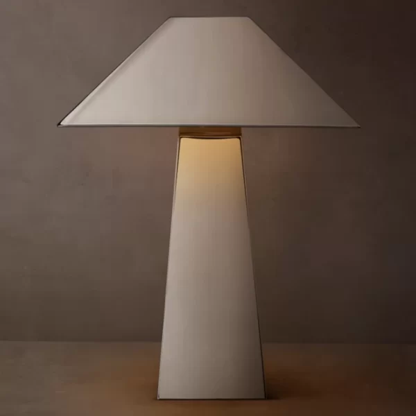 Modern metal table lamp with a white shade and geometric base.
