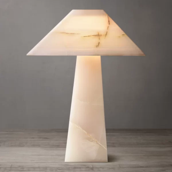 Elegant onyx stone table lamp with obelisk design and warm lighting.