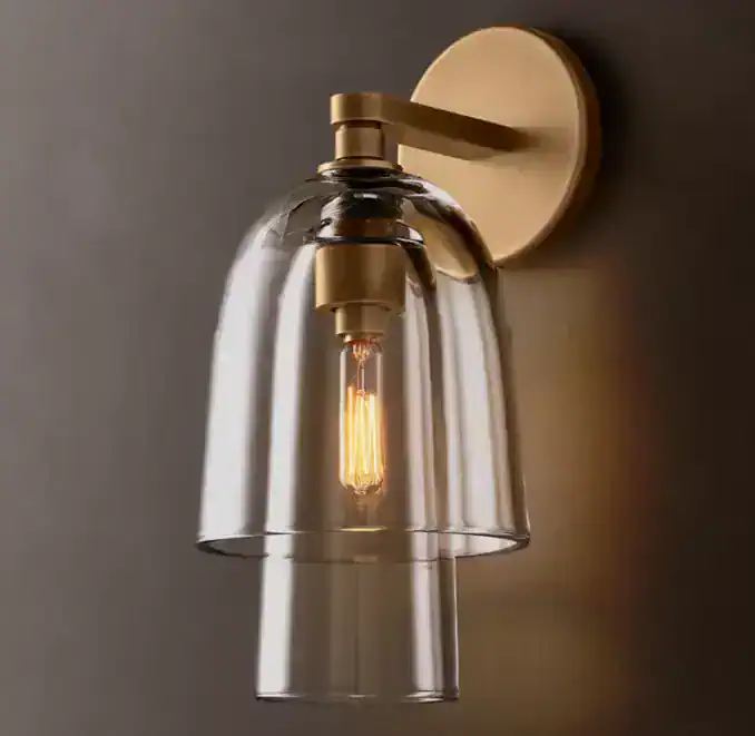Modern glass wall sconce with brass finish for stylish lighting.