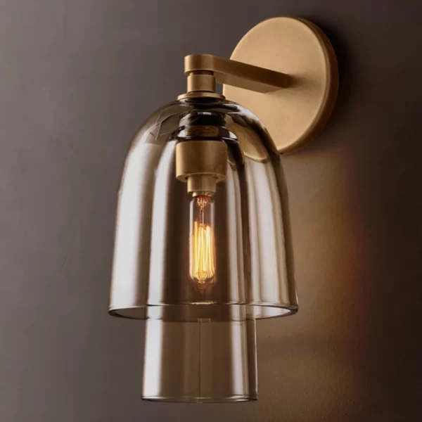 Amber glass wall sconce with brass mount and exposed filament bulb.
