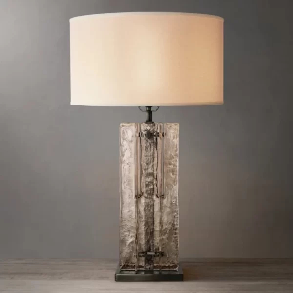Elegant smoke glass table lamp with a modern design and beige lampshade.