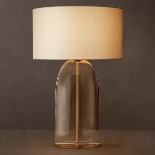 Elegant glass table lamp with steel base and fabric shade for modern decor.
