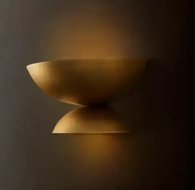 Modern steel sconce with warm lighting for contemporary interior decor.
