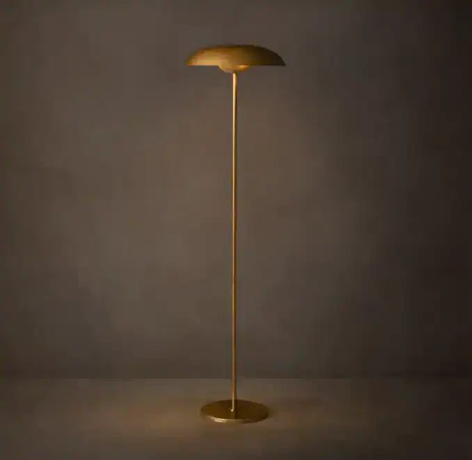 Elegant gold floor lamp with a curved shade and slender stand.