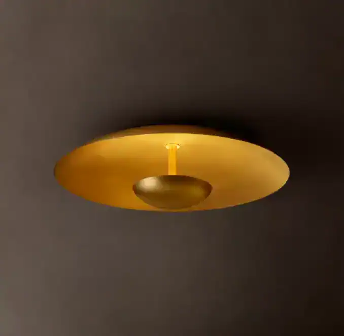 Modern gold steel flushmount ceiling light for elegant interiors.