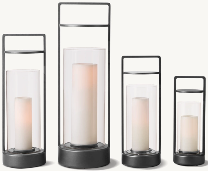 Set of four modern outdoor candle lanterns with black metal frames and glass enclosures.