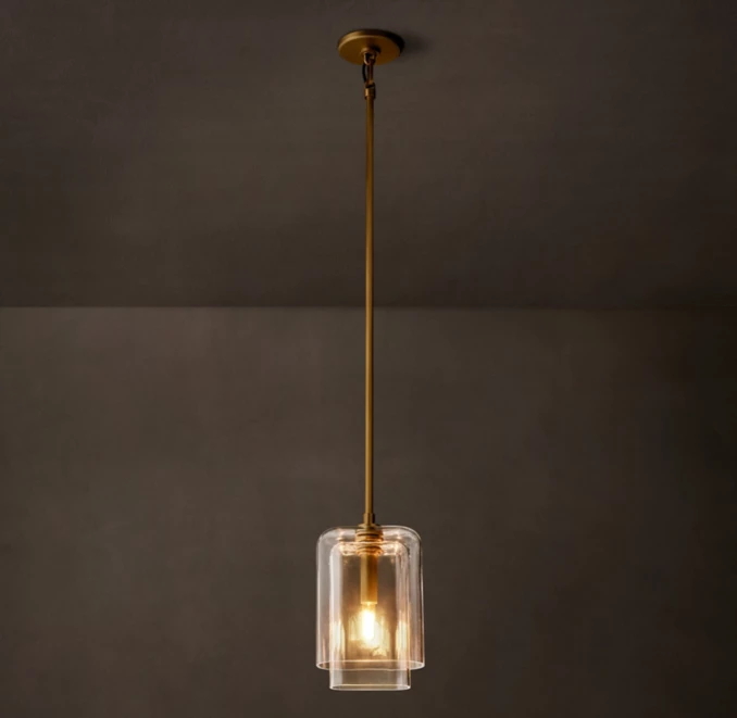 Modern pendant light with clear glass shade and gold fixture.
