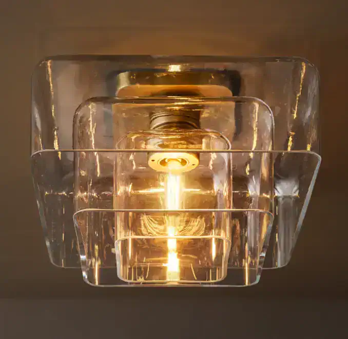 Modern glass flushmount ceiling light with warm illumination.