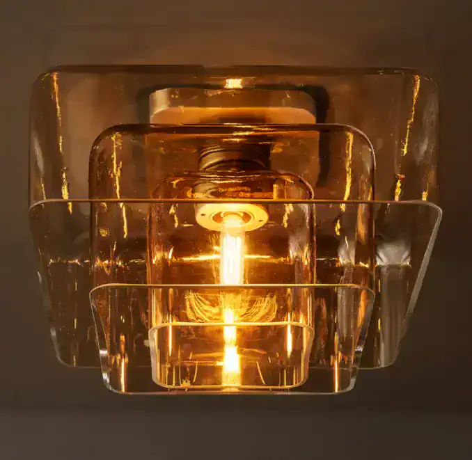 Amber glass ceiling light fixture with modern design and warm glow.