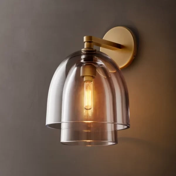 Modern wall sconce with clear glass shade and bronze finish.