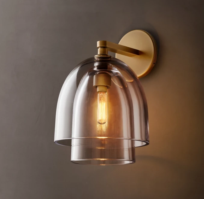 Modern wall sconce with clear glass shade and bronze finish.