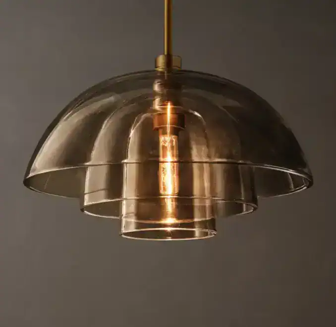 Amber glass pendant light with layered design for modern interiors.