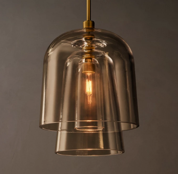 Modern glass pendant light with warm illumination and sleek design.