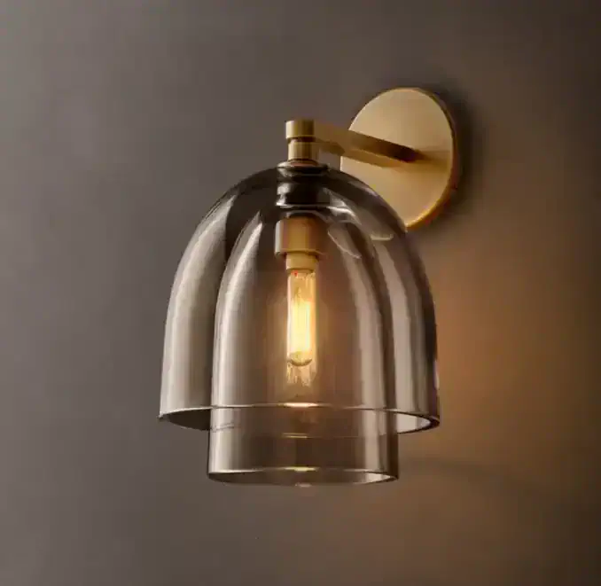 Amber glass wall sconce with brass mount, modern lighting fixture.