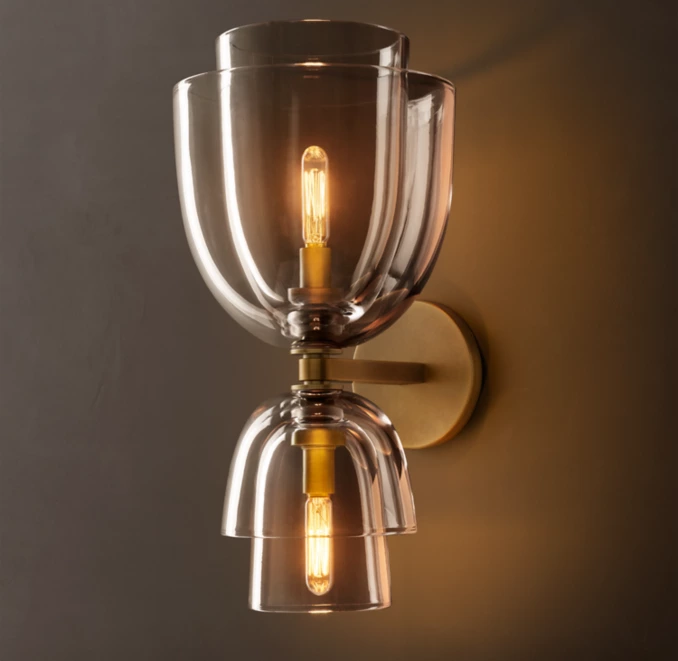 Elegant glass cloche wall sconce with warm lighting for modern interiors.