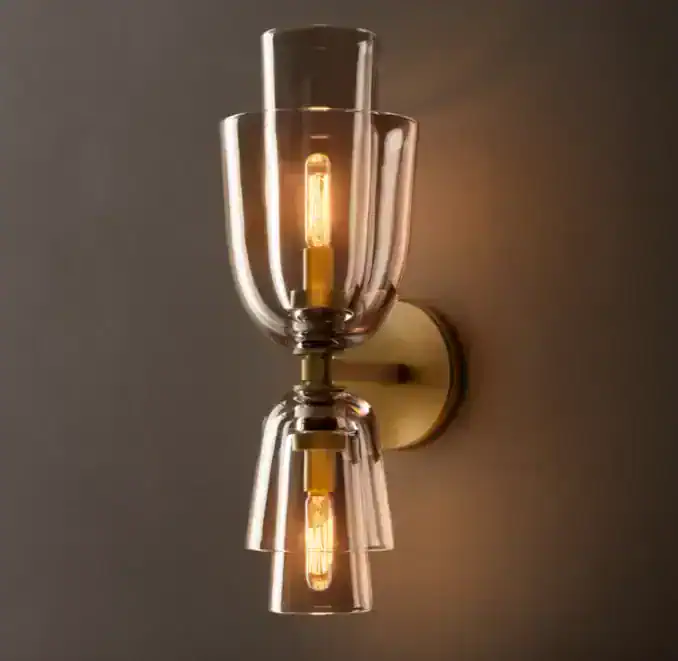 Modern glass wall sconce with exposed filament bulb for stylish lighting.