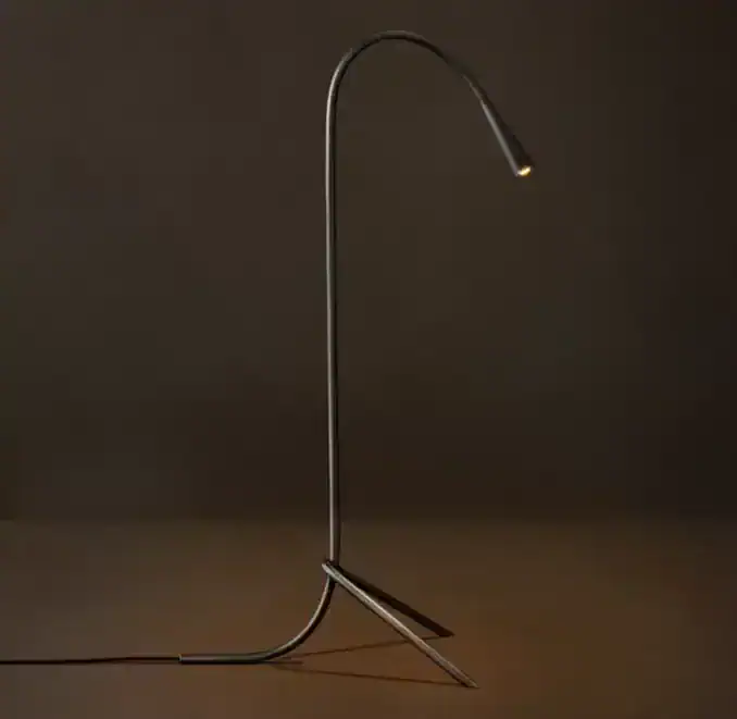 Modern steel task floor lamp with adjustable neck for focused lighting.