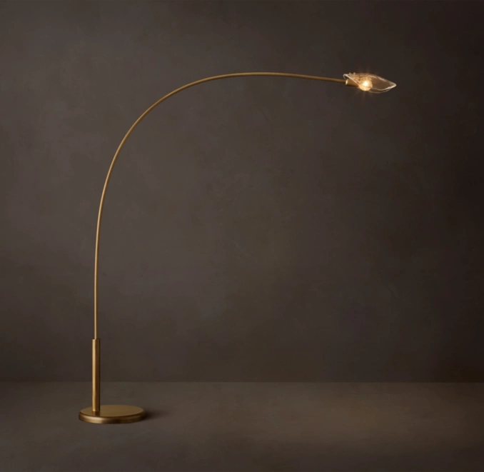 Modern floor lamp with curved brass stem and sleek LED light.