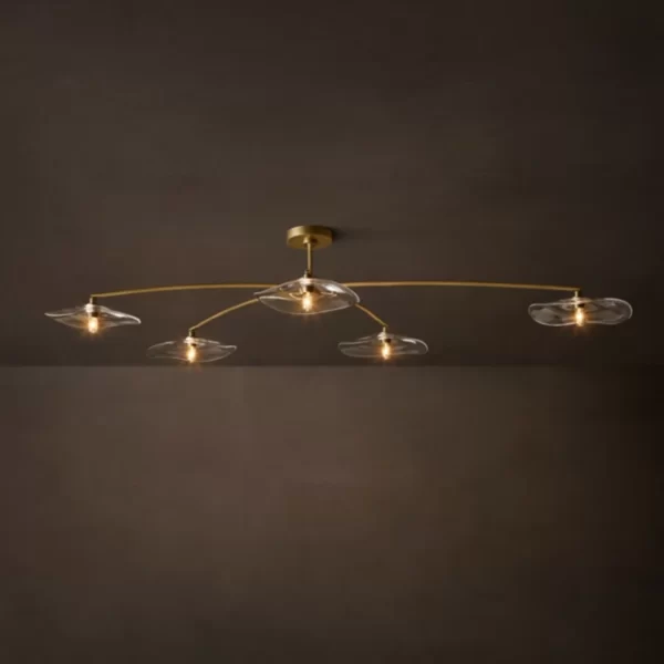 Modern ceiling light fixture with multiple glass shades and gold accents.