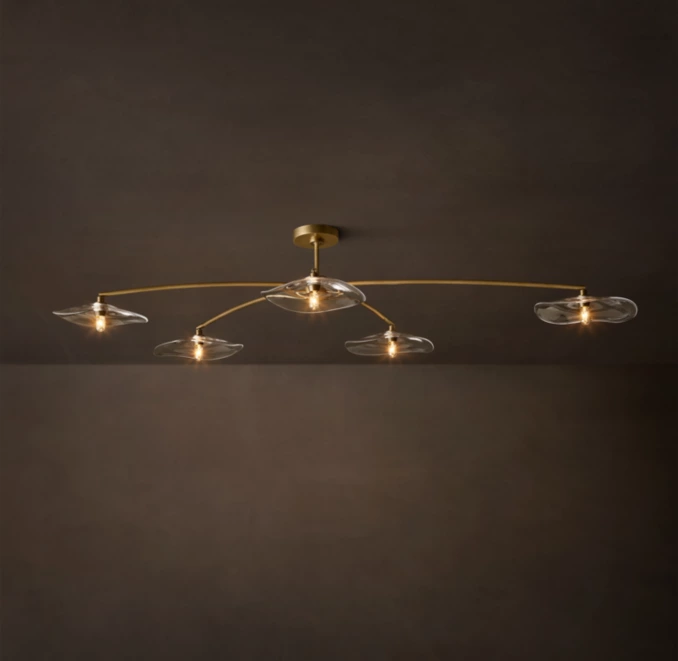 Modern ceiling light fixture with multiple glass shades and gold accents.