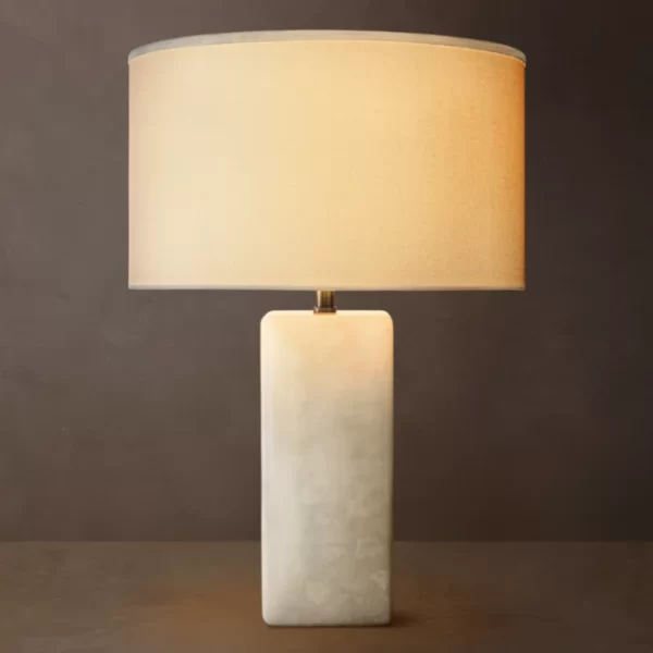 Modern stone table lamp with rectangular base and fabric shade for elegant lighting.