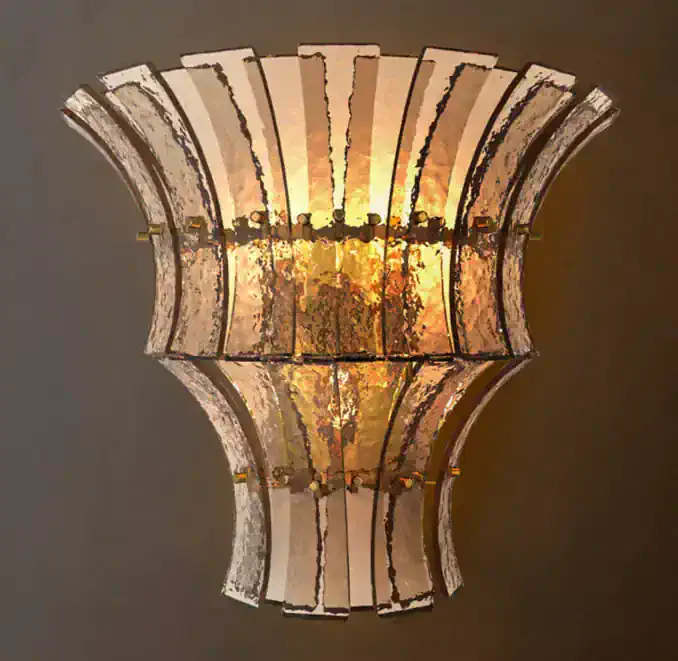 Gorvey lighting wall sconce with a tiered glass design and warm illumination.