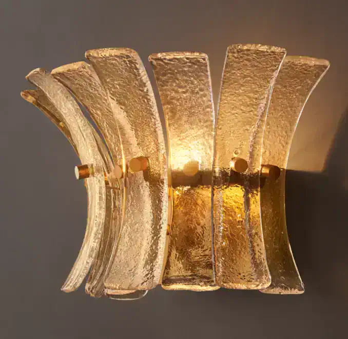 Elegant smoke glass wall sconce with gold accents for modern decor.