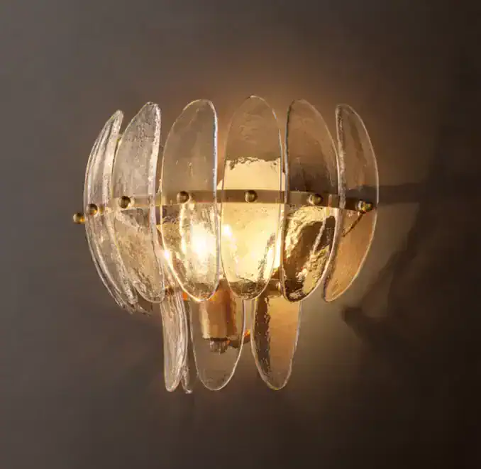 Elegant art glass sconce with curved glass panels and warm lighting.