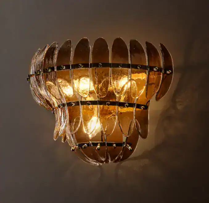 Gorvey Smoke Glass Tiered Sconce with warm lighting for elegant decor.