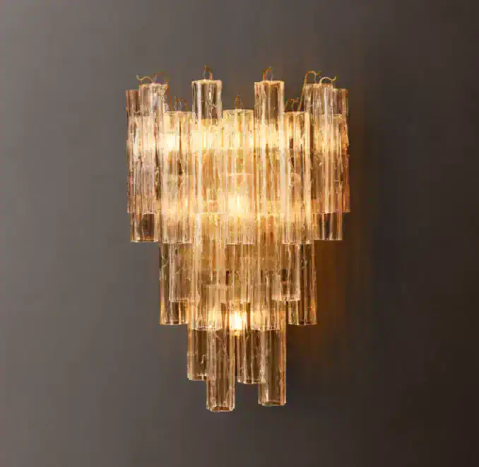 Elegant smoke glass wall sconce with layered glass design and warm lighting.